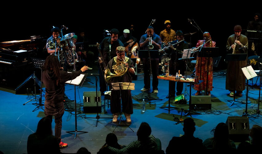 Musicians stand on a stage