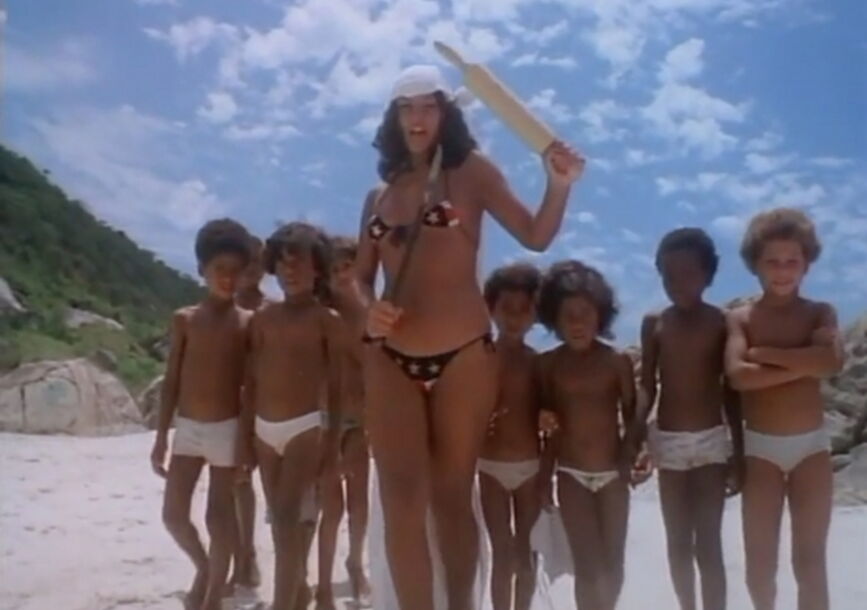 woman in polka dot bikini in front of a group of boys