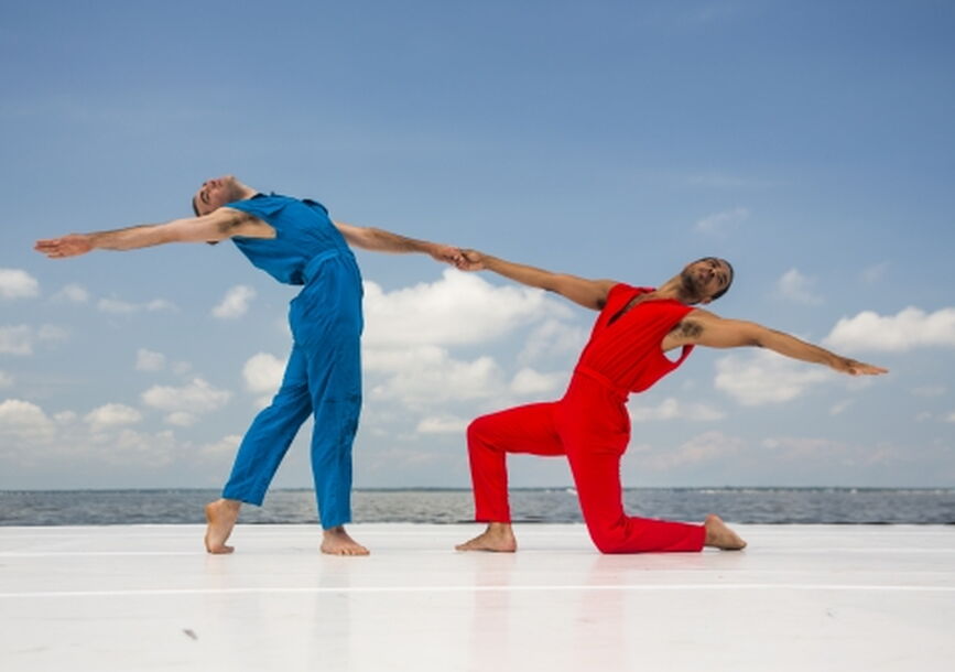 2 dancers one in red and one in blue 