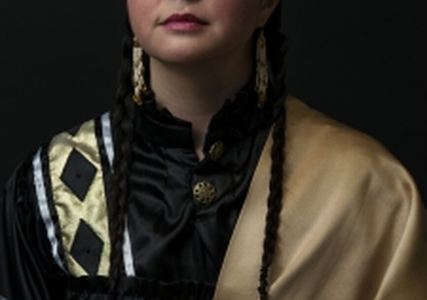 woman in traditional native american style standing posing for photo