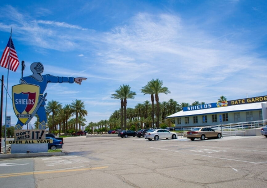 parking lot with a knight statue pointing to a building