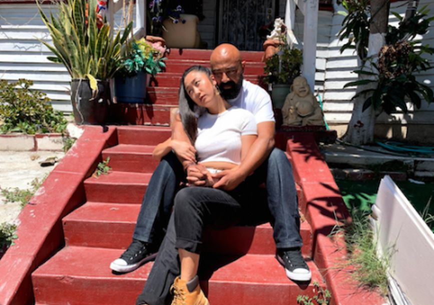 man and woman sitting on front porch stairs together
