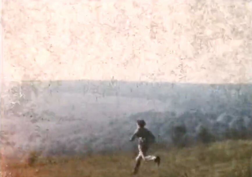 A person runs in a field.