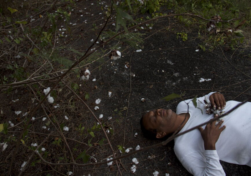 A person lays on the dirt.