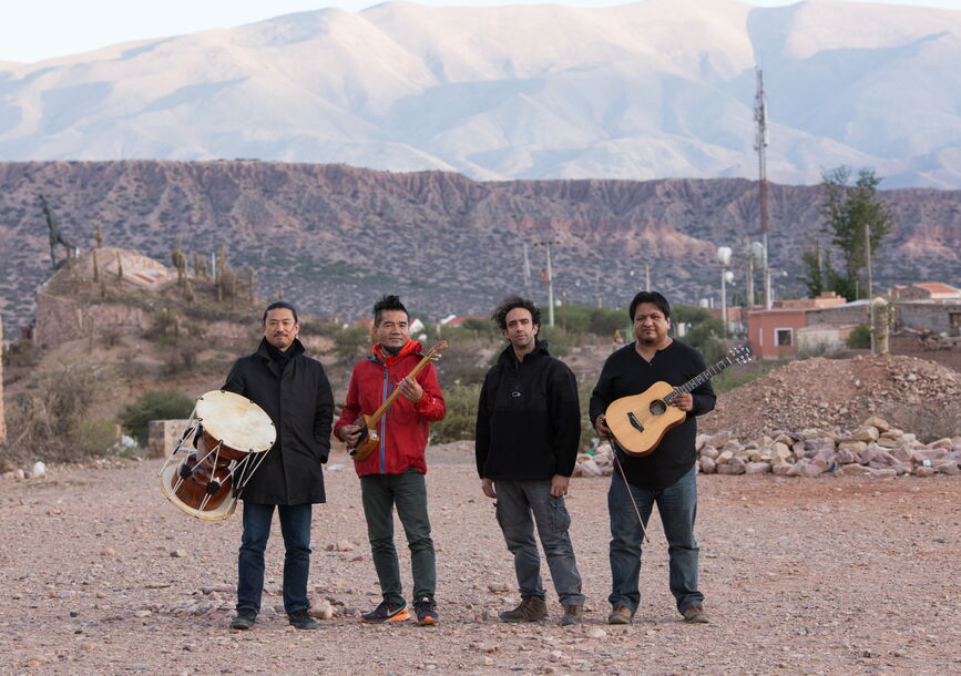 Members of Cuatro Minimal stand in front of a landscape.