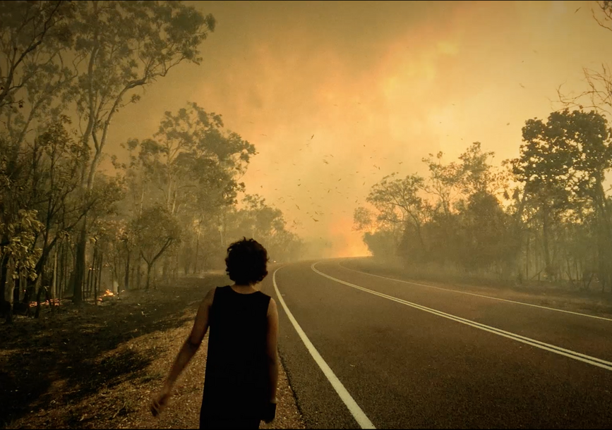 woman walking down the side of a road