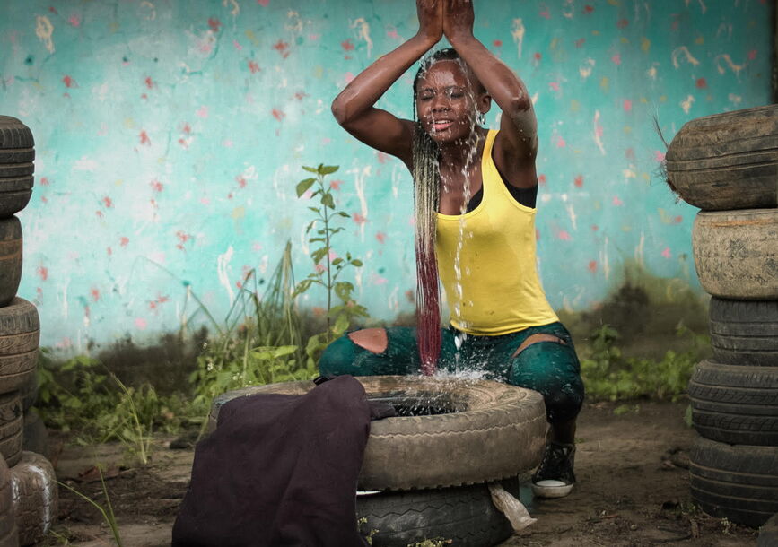 woman pouring water over her head