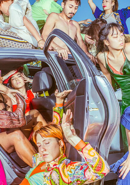 People coming and out of a car.