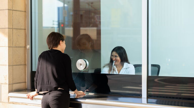 An audience member purchases tickets at the BoxOffice window