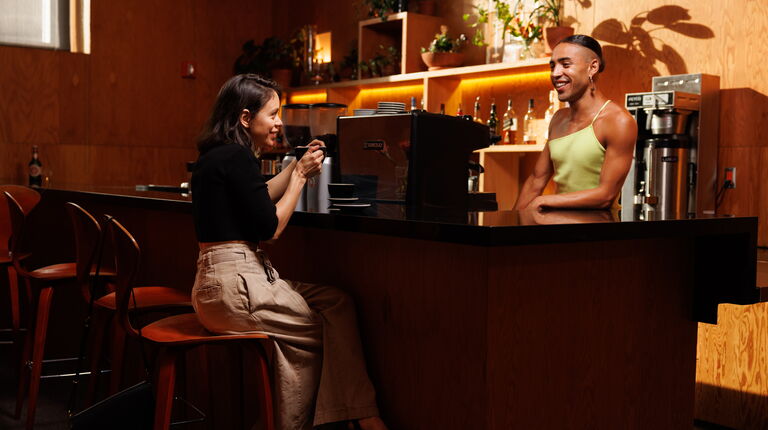Two people have conversation over espresso machine at REDCAT bar 