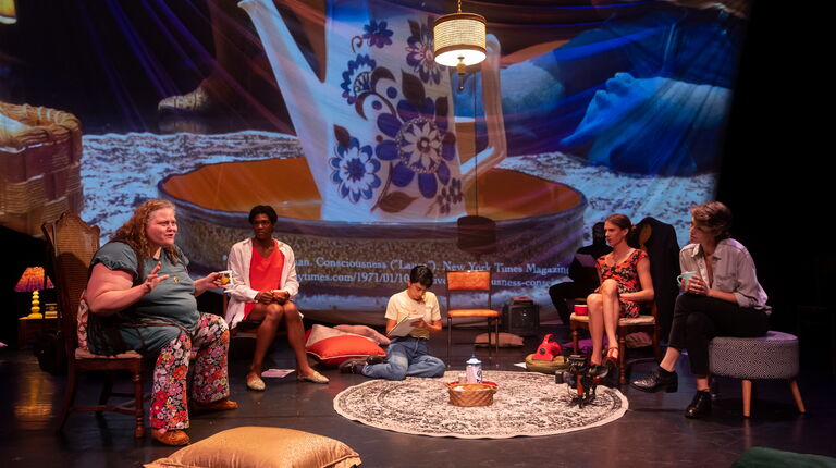 People gather around a living room set.