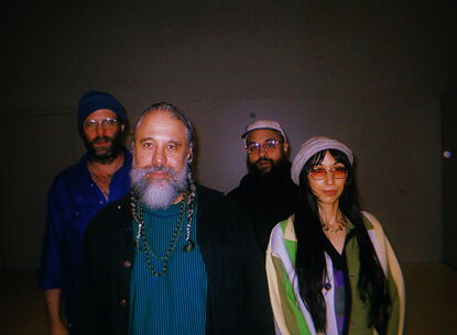 Members of Natural Information Society stand against a wall.