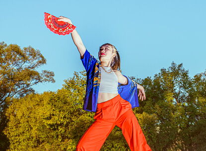 A person stands on top of a car.