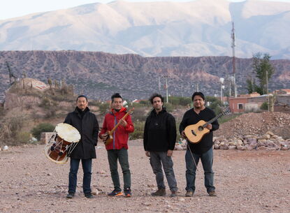 Members of Cuatro Minimal stand in front of a landscape.