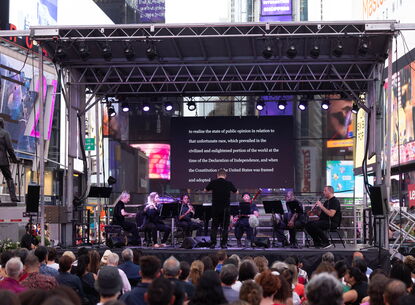 Musicians play on a stage in Times Square.