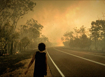 woman walking down the side of a road