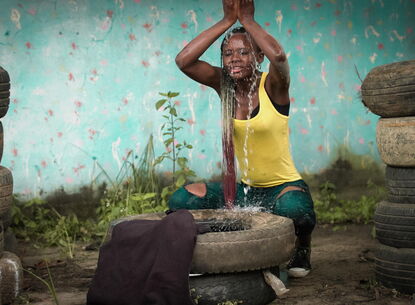 woman pouring water over her head